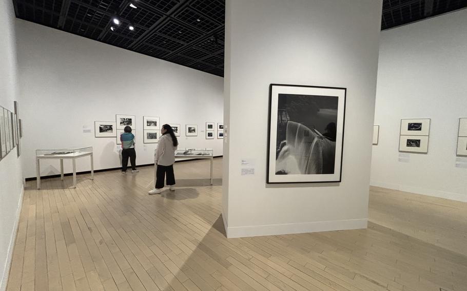 People looking at the artworks on the wall of Tokyo Photographic Art Museum.